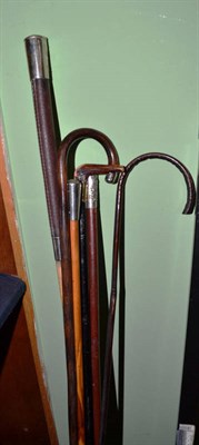 Lot 273 - Two military batons, a leather handled crop and three walking cane