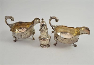 Lot 283 - Two ornate silver sauce boats and a later chased muffineer, London 1770