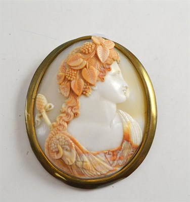 Lot 322 - A Victorian cameo brooch, circa 1880, the shell carved to depict Bacchus, within a plain frame,...