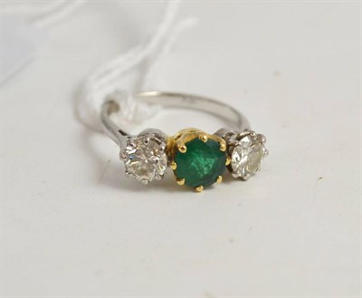 Lot 342 - An emerald and diamond three stone ring, the emerald in a yellow claw setting, a round...