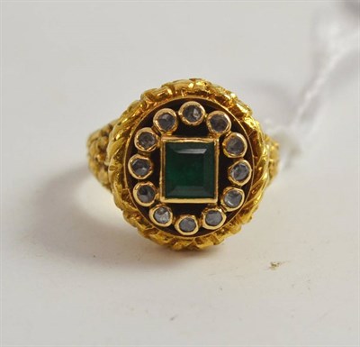 Lot 347 - An 18ct gold emerald and diamond ring, the step-cut emerald within a border of rose cut diamonds in