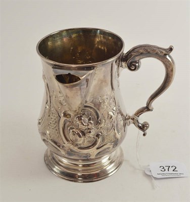 Lot 372 - A Victorian silver mug with repousse decoration and later pouring lip (also hallmarked, London, RH)