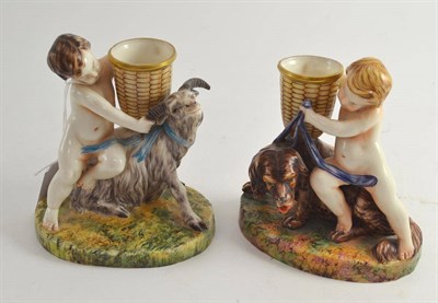 Lot 376 - A pair of Royal Worcester vases modelled with a cherub, a goat and a dog