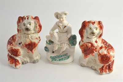 Lot 386 - A pair of Staffordshire spaniels and figure of a boy with dog