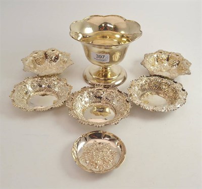 Lot 397 - Two pierced silver bon bon dishes, three silver dishes with shaped rims, another, and a silver...