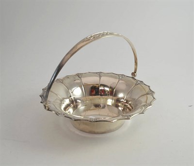 Lot 418 - A continental white metal swing handled basket with pierced rim