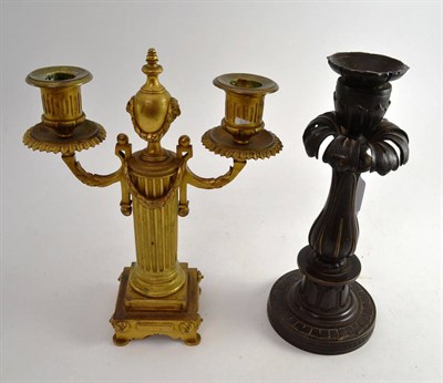 Lot 437 - A gilt metal twin branch candlestick and a bronze candlestick (2)