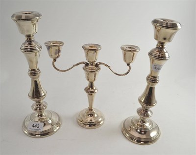 Lot 443 - A pair of Elizabeth II silver candlesticks (filled) Birmingham, 1977, and a similar three...