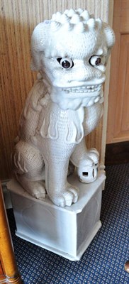 Lot 453 - White faience Buddhistic lion on stand