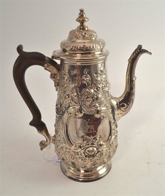 Lot 466 - A George II silver coffee pot, rubbed marks, with later repousse decoration and engraved with a...