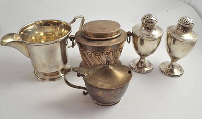 Lot 501 - A pair of silver pepperette, a tea caddy, a cream jug and a mustard