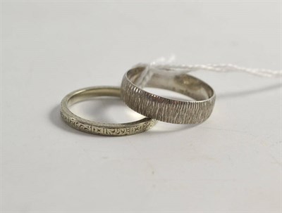 Lot 513 - A platinum band ring and an 18ct white gold band ring