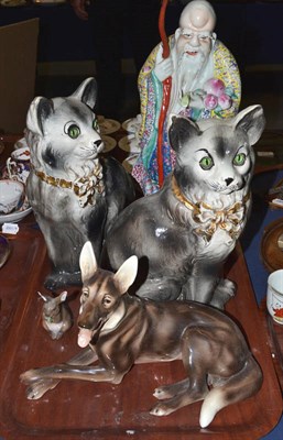 Lot 518 - A glass dome, a 20th century Chinese polychrome figure, two glazed cat ornaments with...