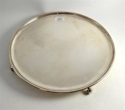 Lot 523 - Circular silver salver with scroll feet