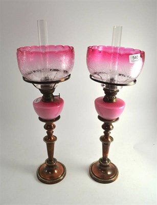 Lot 540 - Two Sheffield plate lamps with pink glass shades