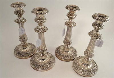 Lot 559 - A set of four George IV silver candlesticks, John & Thomas Settle, Sheffield 1823, the circular...