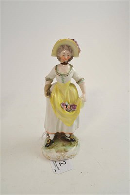 Lot 572 - A Frankenthal figure of a girl, circa 1777, standing wearing a floral hat, holding flowers in...