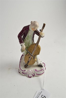 Lot 574 - A German porcelain figure of a cellist, probably Thuringian, circa 1780, the standing figure...