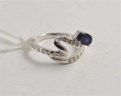 Lot 585 - 18ct white gold diamond and sapphire ring of 'squiggle' form