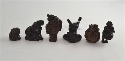 Lot 592 - Six carved hardwood netsukes including one erotic example