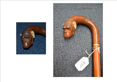 Lot 617 - A Japanese walking stick, the wooden handle carved as a monkeys head with ivory ears and...