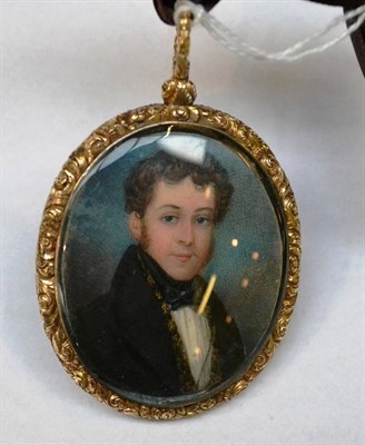 Lot 621 - A portrait miniature of a young man, early 19th century, in carved floral frame