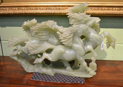 Lot 634 - A jade type centrepiece, 20th century, modelled as five galloping horses on a rocky moulded...