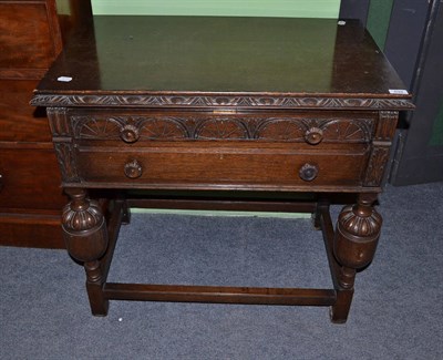 Lot 639 - A quantity of silver plated flatware contained within a carved oak two drawer serving table