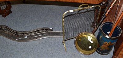 Lot 676 - Two steel fire kerbs, a brass spark guard, a warming pan, two warming sticks, a measuring stick and