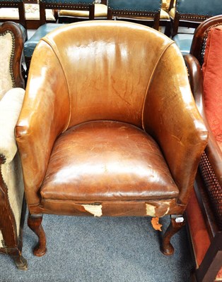 Lot 720 - A 1920s leather upholstered tub chair, in need of recovering