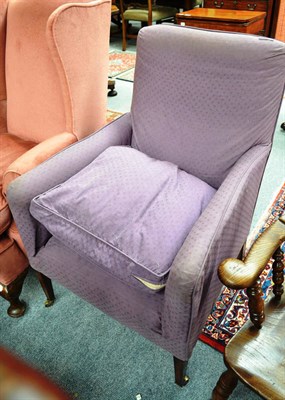 Lot 735 - A small armchair upholstered in purple print fabric, raised on square tapering legs