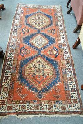 Lot 742 - Meshkin rug, Persian Azerbaijan, the terracotta field with three stepped medallions enclosed by...