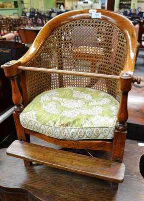 Lot 759 - Early Victorian caned oak child's chair with bar, footrest and green squab