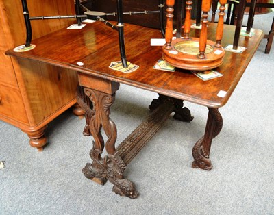 Lot 766 - A carved oak Sutherland table on carved dolphin feet