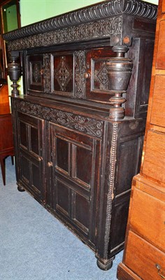 Lot 805 - A carved oak court cupboard