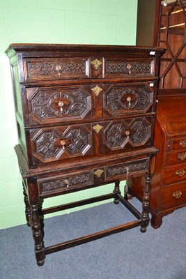 Lot 809 - A carved oak chest on stand