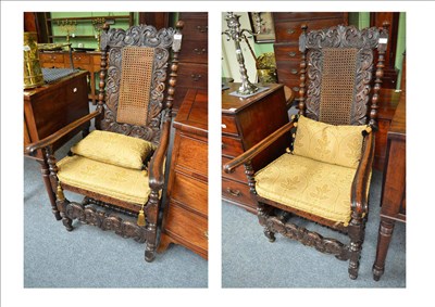 Lot 823 - A matched pair of late 17th century walnut and cane seated open armchairs