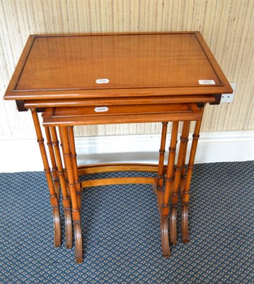 Lot 855 - A nest of three reproduction mahogany nesting tables