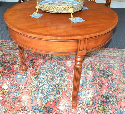 Lot 856 - A reproduction mahogany circular centre table fitted with drawer, raised on reeded legs