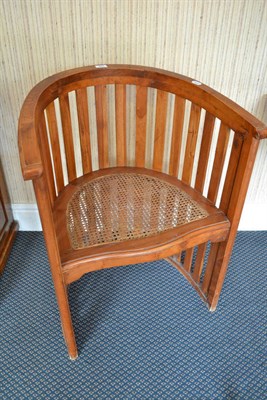 Lot 857 - A hardwood slatted armchair with cane-work seat