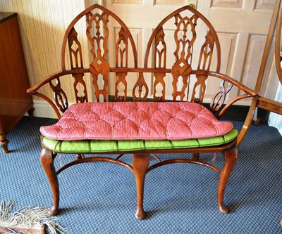 Lot 870 - Small yew wood Gothic chair back settee with two squabs in pink and green