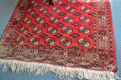 Lot 872 - Tekke rug North West Afghanistan, the faded rose field with five columns of quartered guls enclosed