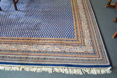 Lot 875 - Large wool ground modern Persian style carpet, the mid indigo field with an all over design of...