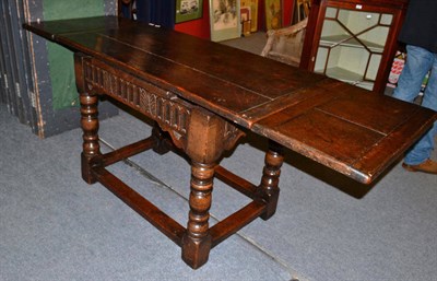 Lot 890 - An oak extending dining table, in 17th century style, probably 19th century, of two-plank...