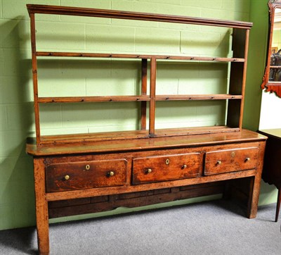 Lot 892 - A joined oak dresser, the solid top above three deep frieze drawers, enclosed panel sides and back