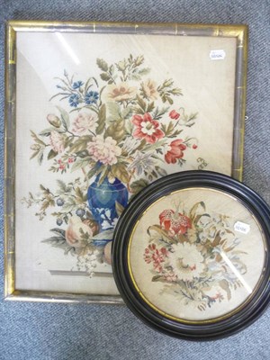 Lot 1022 - A petit point picture of fruit and flowers and a small circular petit point picture in ebony...