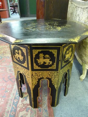 Lot 1089 - A black and gilt japanned octagonal folding table,the lower section decorated with Chinese dragons