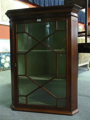 Lot 1097 - A late George III mahogany glazed hanging corner cupboard