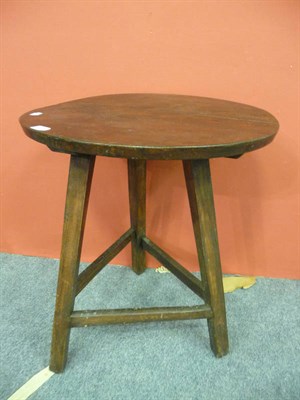 Lot 1104 - Oak cricket table on stained pine legs