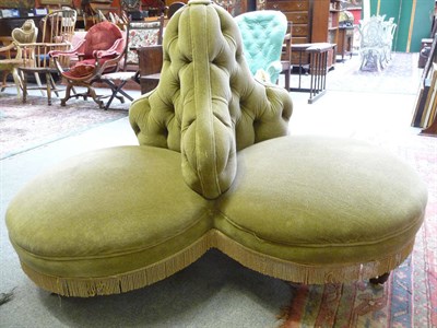 Lot 1105 - A green upholstered conversation seat